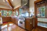 Experience rustic elegance in this stunning kitchen, featuring rich wood cabinetry and a professional-grade Wolf range.