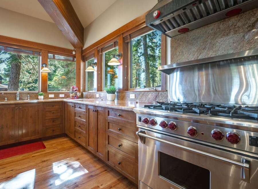 Experience rustic charm and modern convenience in this stunning kitchen, featuring rich wooden cabinetry and granite countertops.