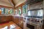 Experience rustic charm and modern convenience in this stunning kitchen, featuring rich wooden cabinetry and granite countertops.