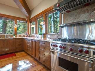 Experience rustic charm and modern convenience in this stunning kitchen, featuring rich wooden cabinetry and granite countertops.