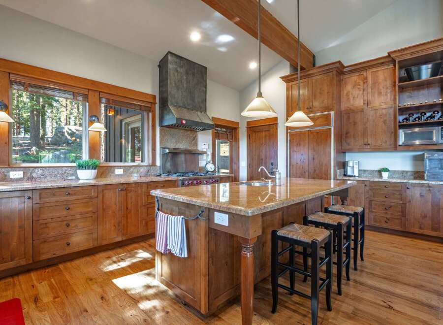 Experience rustic charm in this spacious kitchen featuring custom wood cabinetry and granite countertops.