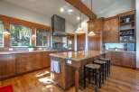 Experience rustic charm in this spacious kitchen featuring custom wood cabinetry and granite countertops.