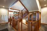 Experience the grandeur of this stunning home featuring a magnificent wooden staircase that serves as the centerpiece of the entryway.