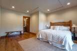 Experience rustic charm in this inviting bedroom featuring a unique log headboard and a cozy quilted bedspread.