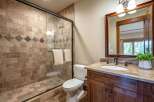 Experience luxury in this beautifully appointed bathroom, featuring a spacious walk-in shower with elegant tilework and a decorative accent band.