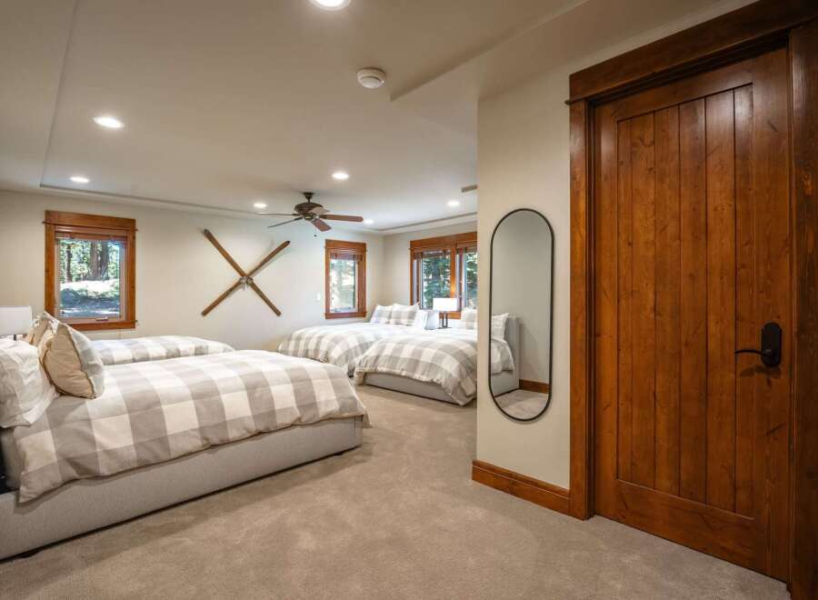 This spacious bedroom features multiple comfortable beds, perfect for accommodating family or guests.