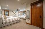 This spacious bedroom features multiple comfortable beds, perfect for accommodating family or guests.