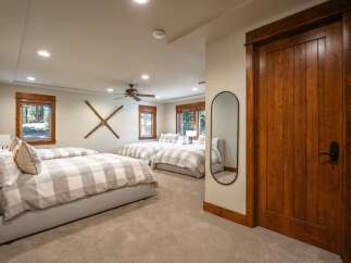 This spacious bedroom features multiple comfortable beds, perfect for accommodating family or guests.