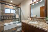 This beautifully appointed bathroom features a spacious walk-in shower with elegant tile work and a convenient bathtub.