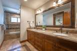 This spacious bathroom features a double vanity with granite countertops and ample storage, perfect for any household.
