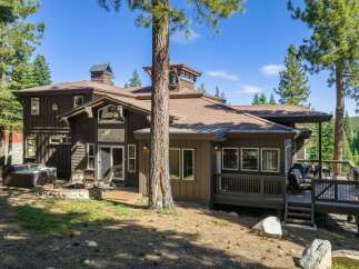 Experience mountain living in this stunning property featuring a spacious deck perfect for entertaining and a relaxing hot tub.
