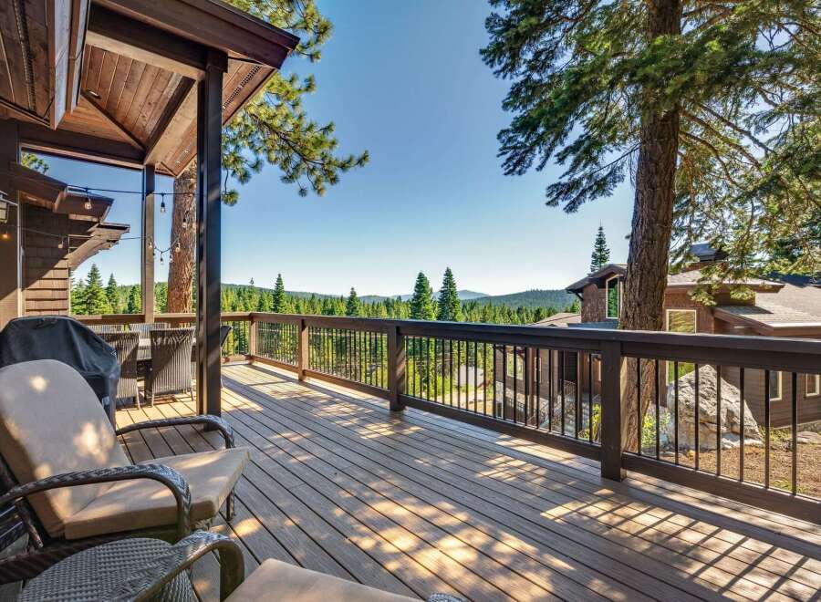Enjoy breathtaking mountain views from this expansive wooden deck, perfect for outdoor entertaining.