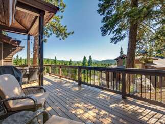 Enjoy breathtaking mountain views from this expansive wooden deck, perfect for outdoor entertaining.