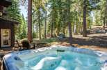Indulge in ultimate relaxation with this luxurious hot tub, perfectly situated on a private deck surrounded by a serene forest landscape.
