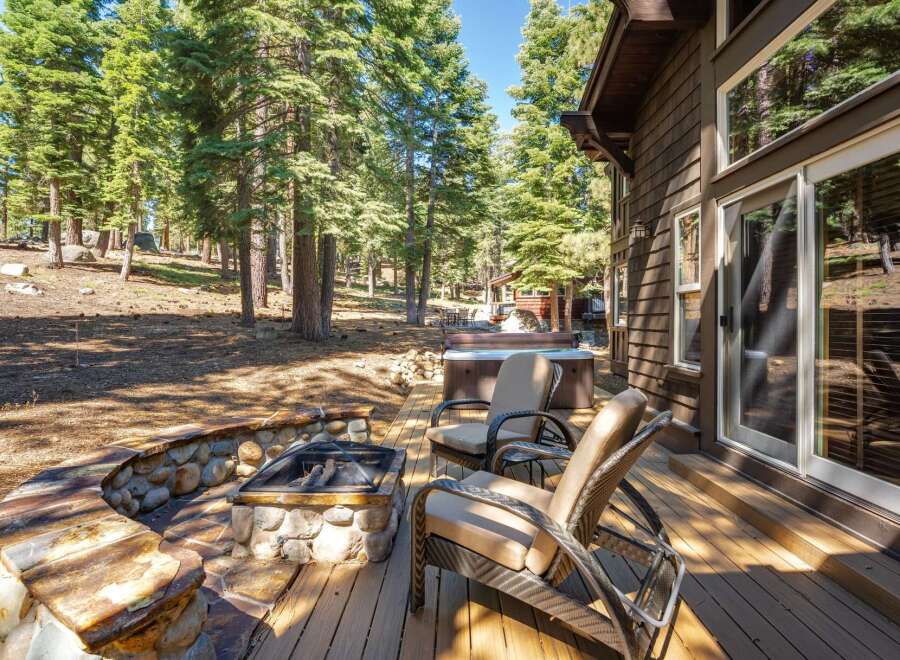Enjoy the ultimate outdoor living experience with this stunning property featuring a luxurious hot tub and a charming stone fire pit.