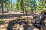 Enjoy the serene mountain lifestyle with this stunning property featuring a cozy stone fire pit and a luxurious hot tub, perfect for relaxing evenings.