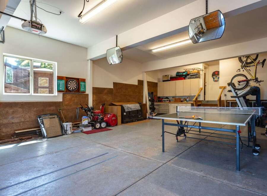 This spacious garage offers a versatile space for both storage and recreation.