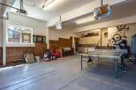This spacious garage offers a versatile space for both storage and recreation.