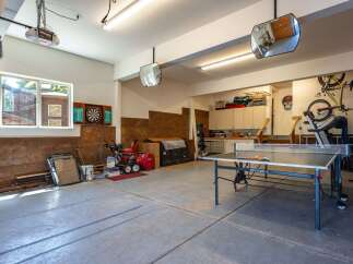 This spacious garage offers a versatile space for both storage and recreation.