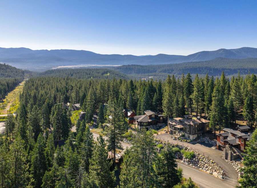 Nestled amidst a dense forest of towering pine trees, this stunning property offers a serene mountain retreat.