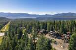 Nestled amidst a dense forest of towering pine trees, this stunning property offers a serene mountain retreat.