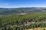 Nestled amidst a dense forest of towering pine trees, this property offers a serene mountain retreat.