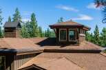 Experience the architectural charm of this mountain retreat, featuring a distinctive multi-level roofline and a prominent dormer window.