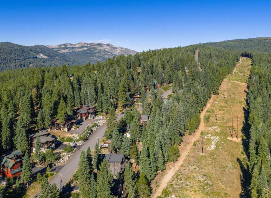 Nestled amidst a dense forest of evergreen trees, this stunning mountain property offers a serene and private retreat.
