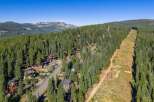 Nestled amidst a dense forest of evergreen trees, this stunning mountain property offers a serene and private retreat.