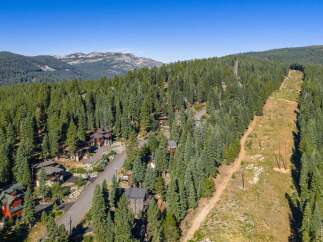 Nestled amidst a dense forest of evergreen trees, this stunning mountain property offers a serene and private retreat.