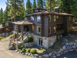Experience luxury mountain living in this stunning custom-built home nestled among tall pines.