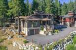 Nestled amidst towering pine trees, this stunning mountain home offers a luxurious retreat with its multi-level design and natural stone accents.