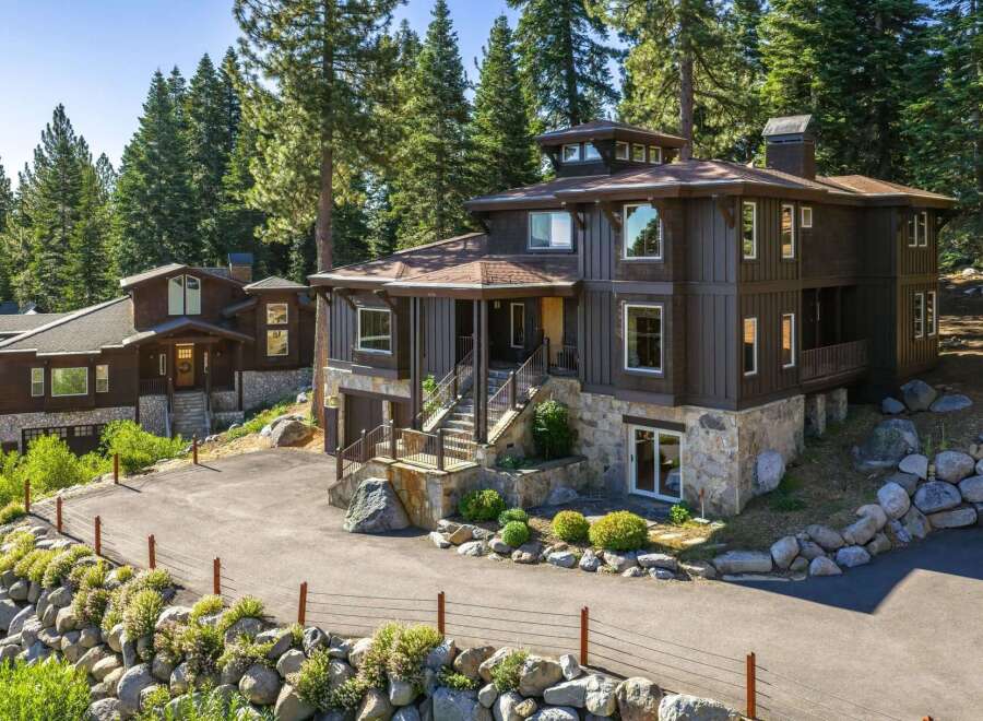 Nestled amidst towering pine trees, this stunning multi-level home offers a luxurious mountain retreat.
