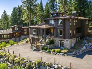Nestled amidst towering pine trees, this stunning multi-level home offers a luxurious mountain retreat.