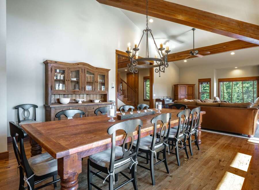 Experience rustic elegance in this spacious dining room, featuring a large, reclaimed wood table perfect for gatherings.