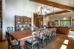 Experience rustic elegance in this spacious dining room, featuring a large, reclaimed wood table perfect for gatherings.