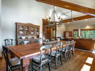 Experience rustic elegance in this spacious dining room, featuring a large, reclaimed wood table perfect for gatherings.
