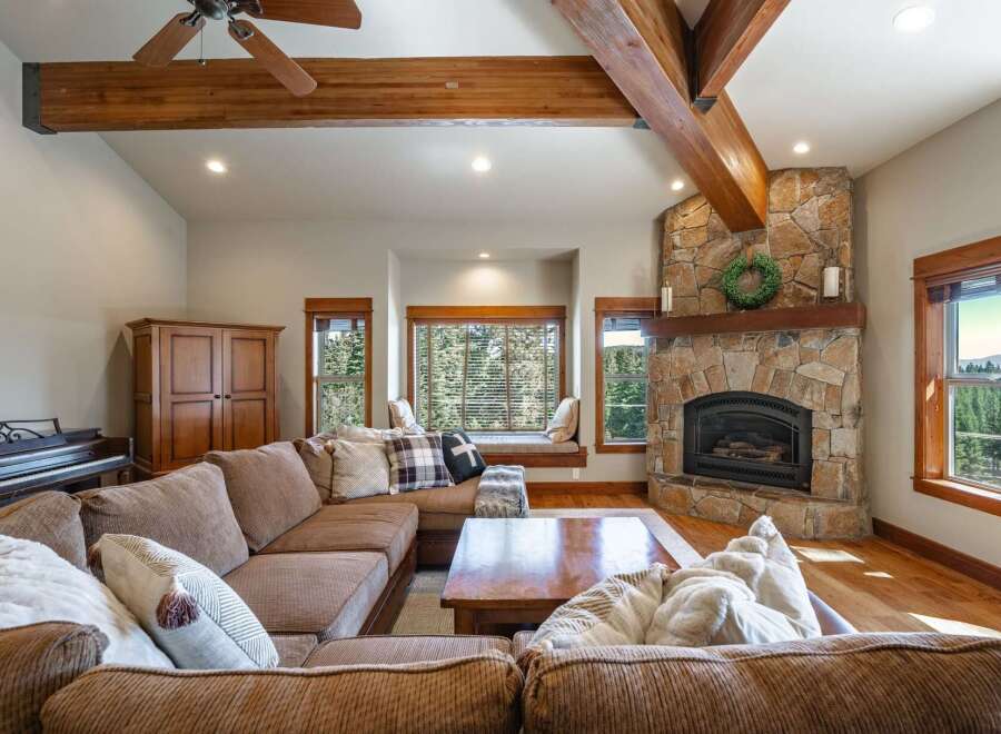 Experience rustic charm in this inviting living room, featuring a grand stone fireplace as the centerpiece.