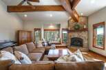 Experience rustic charm in this inviting living room, featuring a grand stone fireplace as the centerpiece.