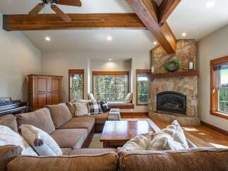 Experience rustic charm in this inviting living room, featuring a grand stone fireplace as the centerpiece.