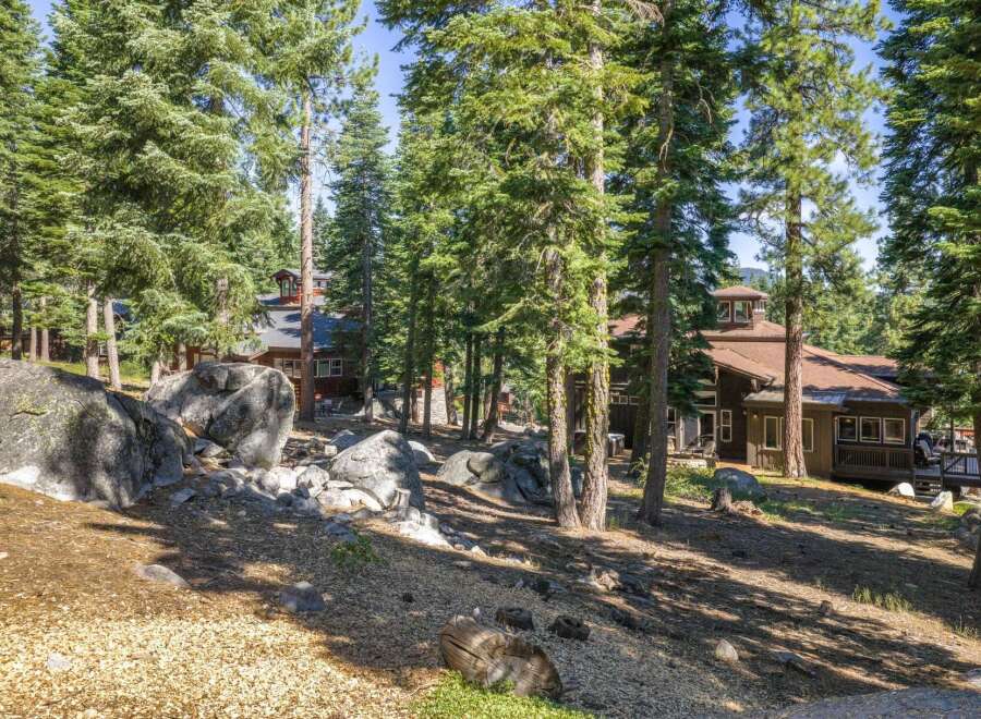 Nestled amidst towering pine trees and large granite boulders, this property offers a serene mountain retreat.