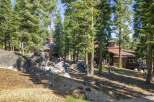 Nestled amidst towering pine trees and large granite boulders, this property offers a serene mountain retreat.