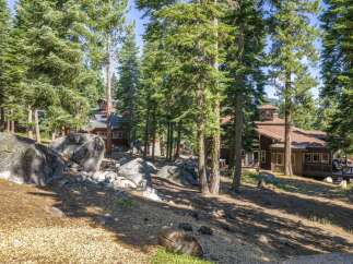 Nestled amidst towering pine trees and large granite boulders, this property offers a serene mountain retreat.