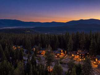 Nestled amidst a dense forest, this stunning property offers a serene mountain retreat.