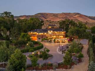 Experience luxury living in this stunning multi-level estate, nestled against a backdrop of majestic mountains.