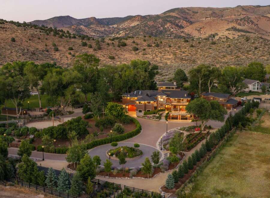 Experience luxurious living in this expansive estate, nestled against a backdrop of majestic mountains.