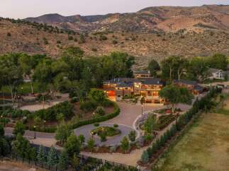 Experience luxurious living in this expansive estate, nestled against a backdrop of majestic mountains.