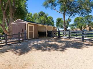 Discover this charming equestrian property featuring a well-maintained stable with two stalls and a tack room, perfect for housing your horses.