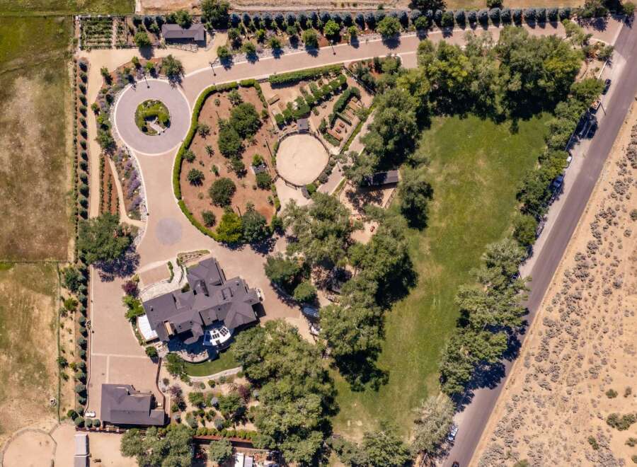 Discover this expansive estate featuring a luxurious main residence and a separate guest house, perfect for multi-generational living or hosting visitors.