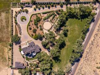 Discover this expansive estate featuring a luxurious main residence and a separate guest house, perfect for multi-generational living or hosting visitors.